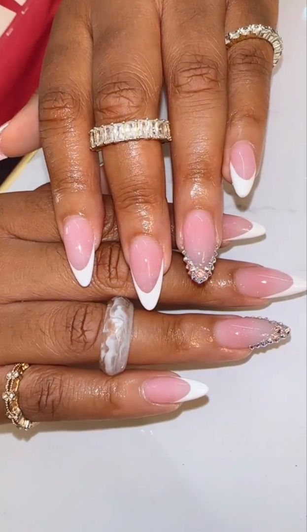 Chic Soft Pink and White Pointed Nail Design with Rhinestones and Marbled Accent.