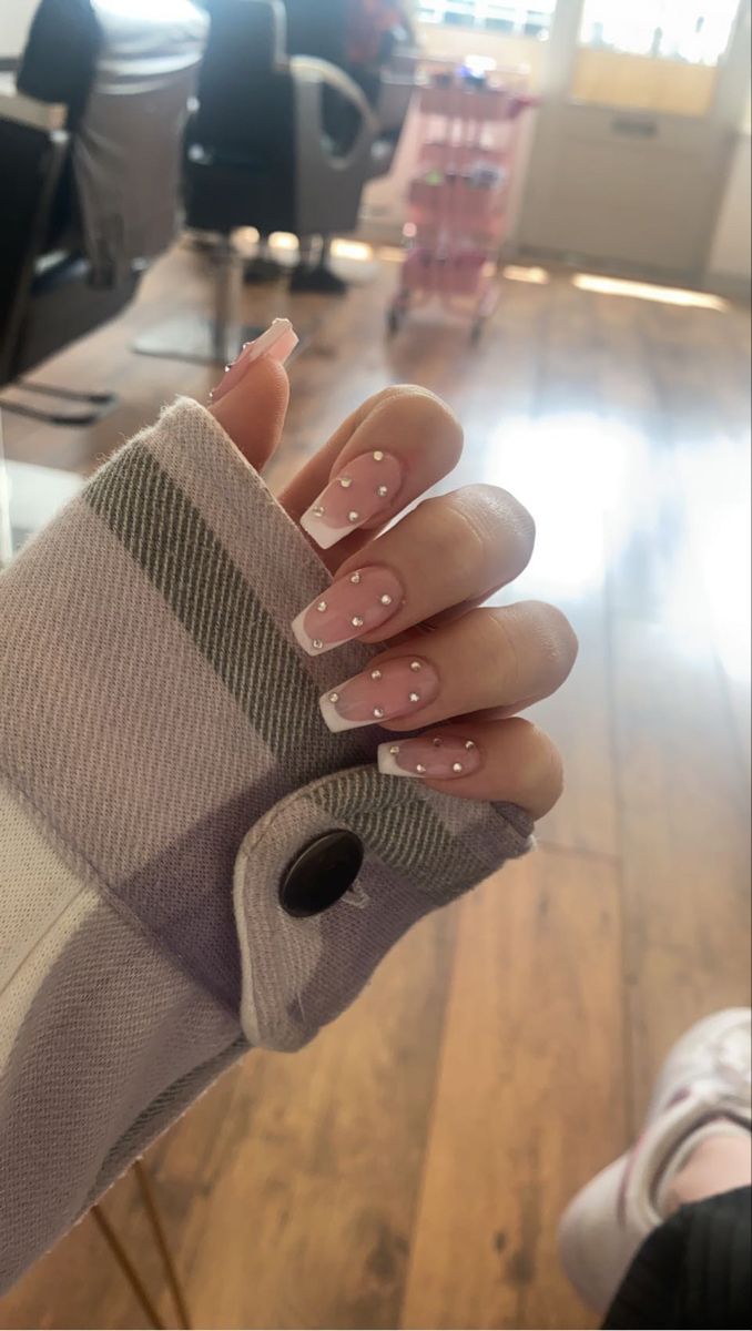 Sophisticated Soft Pink Nail Design with White Dots and Rhinestones