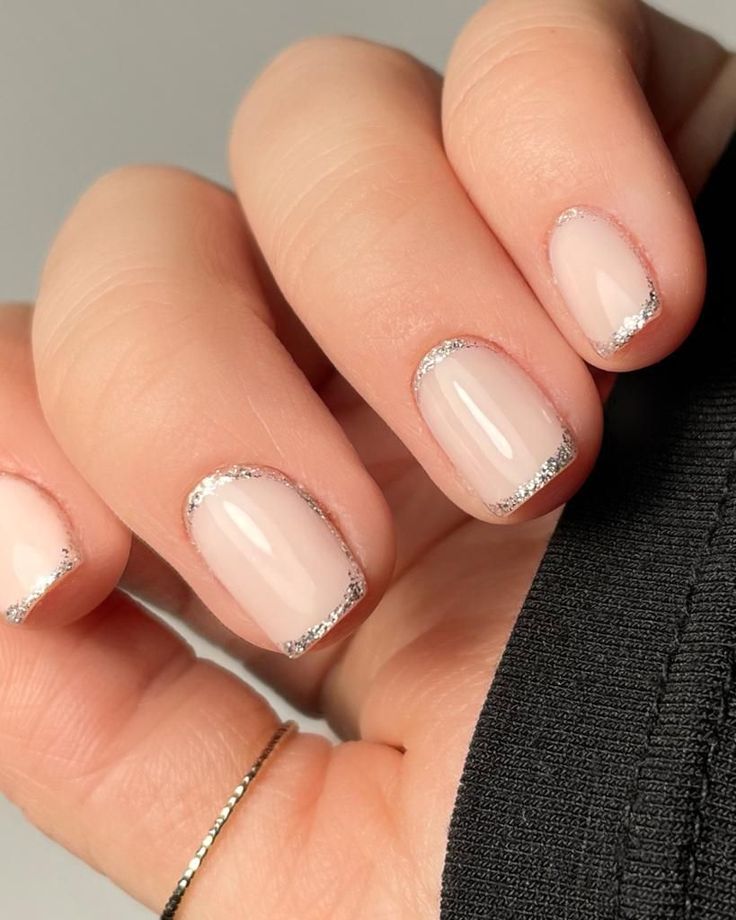 Sophisticated Nude Manicure with Delicate Silver Glitter Tips.