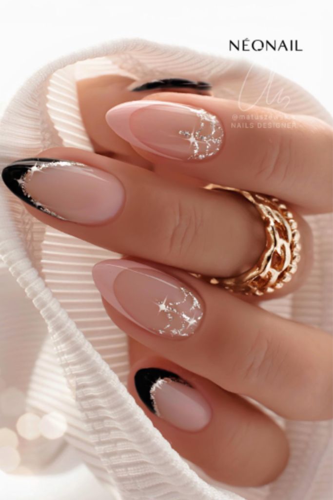 Sophisticated Elegant Nail Design: Nude and Black with Glossy Finish and Silver Accents.