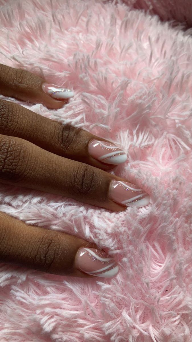 Sophisticated Soft Pink Nail Design with Chic Swirls and Subtle Glitter Accents.