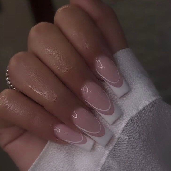 Chic Modern Manicure: Soft Pink Gradient with Elegant White Tips and Curved Lines.