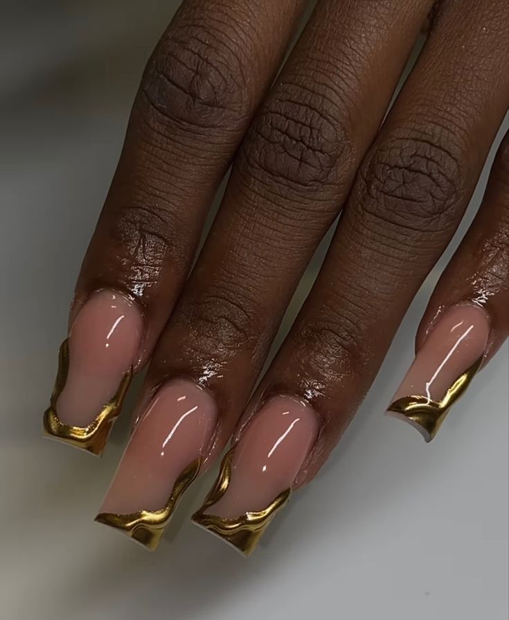 Sophisticated Nude Nails with Bold Gold Accents for Any Occasion