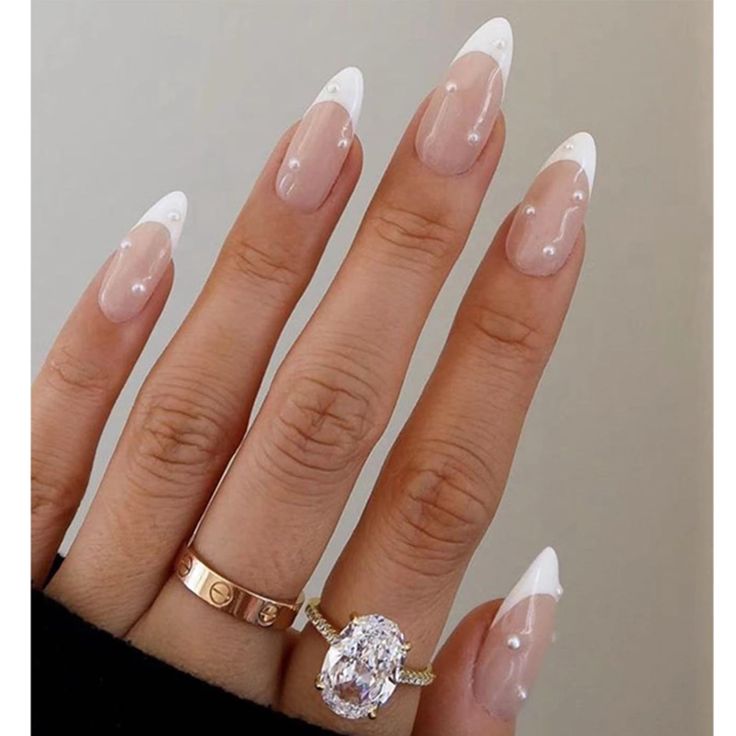 Sophisticated Nail Design: Elegant Long Tapered Tips with French Manicure and Glamorous Accents.