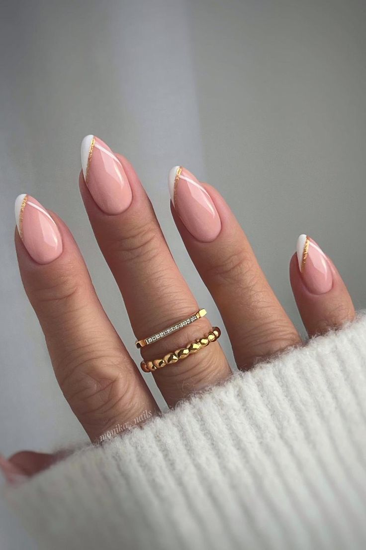 Chic Soft Pink and White French Tip Nails Enhanced with Delicate Gold Accents.