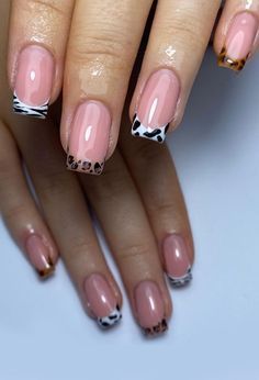 Trendy Chic Nail Design: Glossy Nude Base with Bold Animal Print Tips.