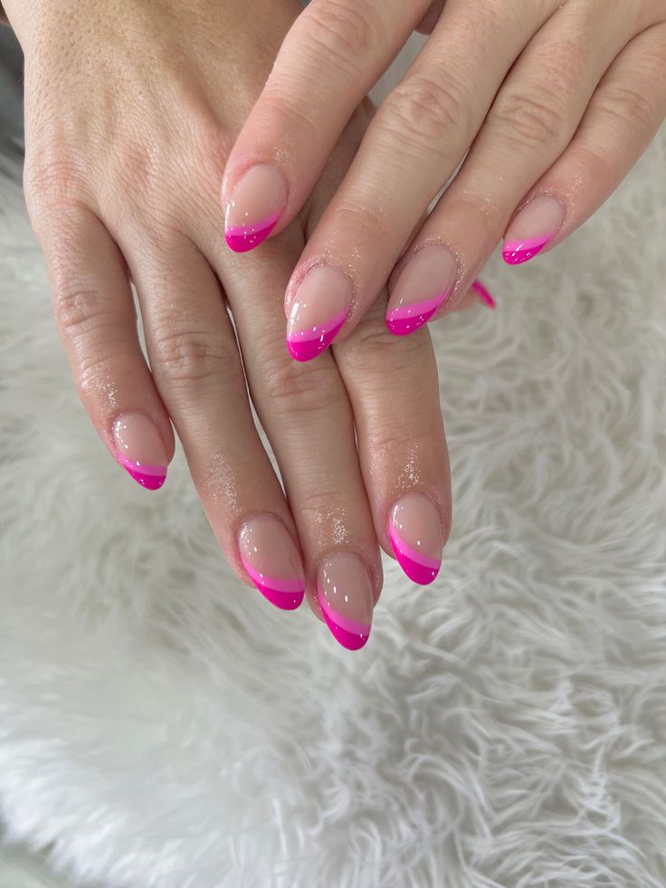 Playful Elegance: Vibrant Pink French Tips on Naturally Shaped Nails.