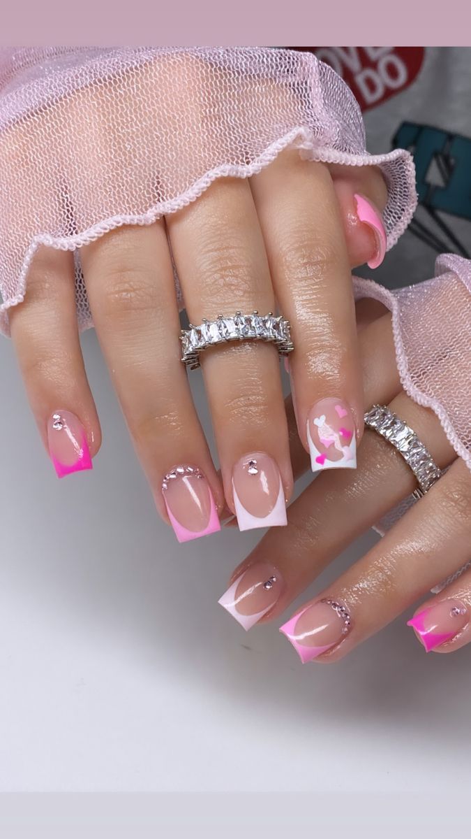 Elegant Playfulness: Soft Pink and White Nail Design with Rhinestones and Abstract Art