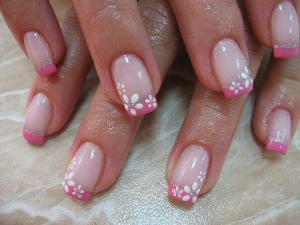 Charming Floral Nail Design with Soft Pink Tips and Elegant White Accents.