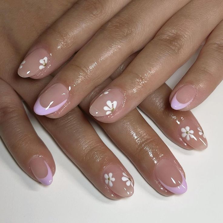 Elegant Nude and Lavender Floral Nail Design with Glossy Finish and Playful Tips.