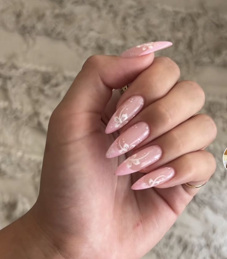 Sophisticated Pink Pointed Nail Design with Floral Accents