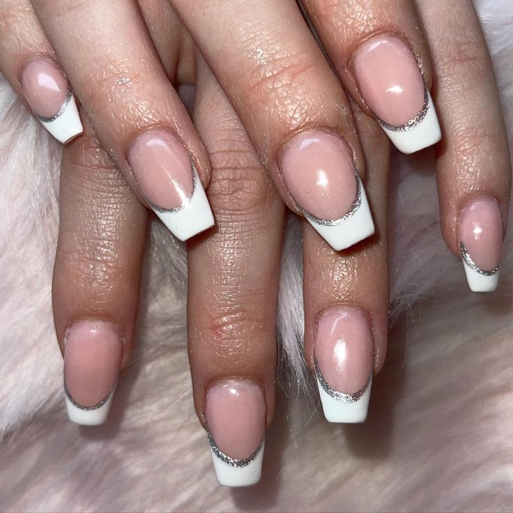 Chic French-Tip Manicure with Soft Pink Polish and Glamorous Silver Accents