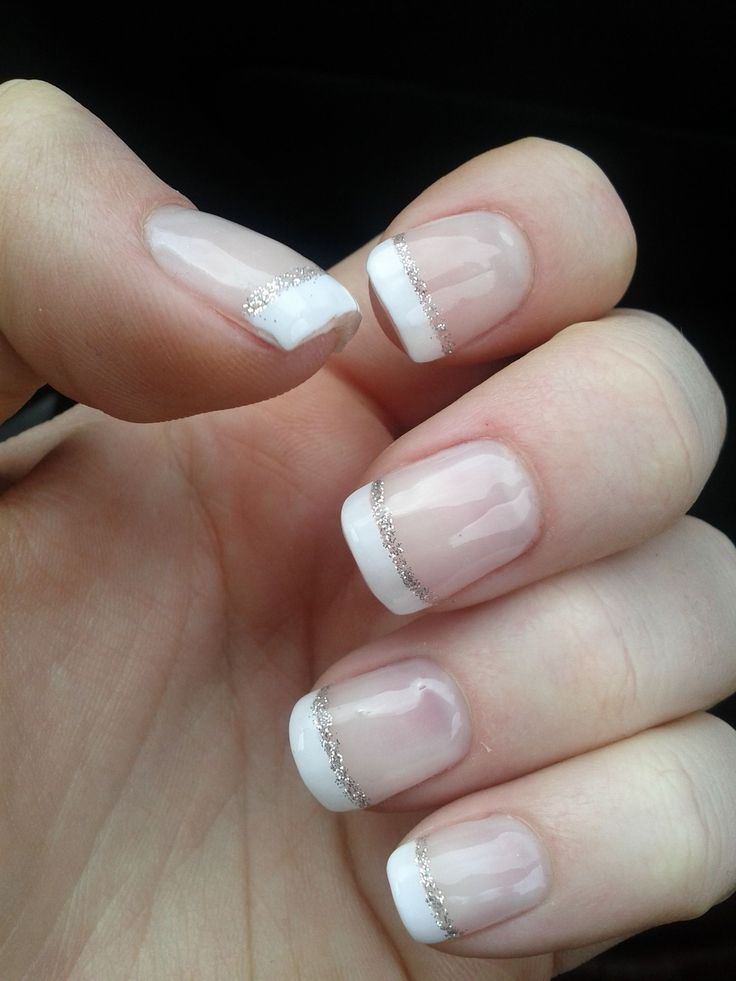 Sophisticated French Manicure with Glitter Accents and Soft Pink Base.