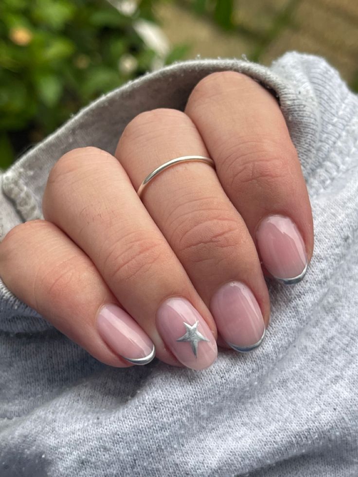 Charming Soft Pink Nail Design with Silver Accents and Whimsical Star Embellishments.