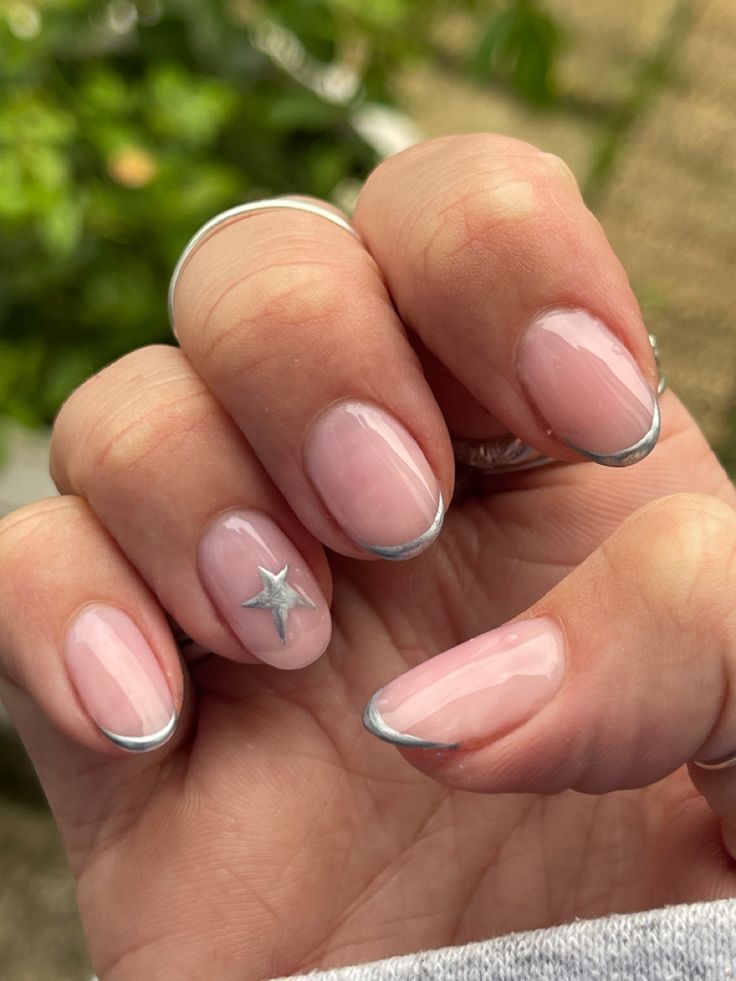 Elegant Soft Pink Nail Design with French Tip and Silver Star Accent