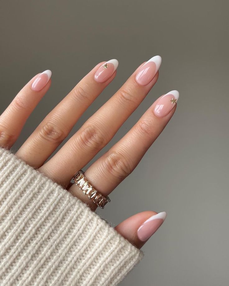 Chic French Manicure: Soft Pink Base with White Tips and Whimsical Gold Star Accents