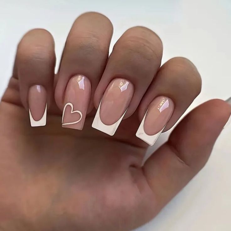 Charming Nude and White Nail Design with Heart Detail for Versatile Elegance.