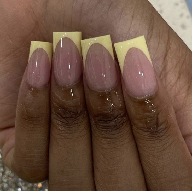 Modern French Tip Nail Design: Soft Pink Base with Bold Yellow Tips