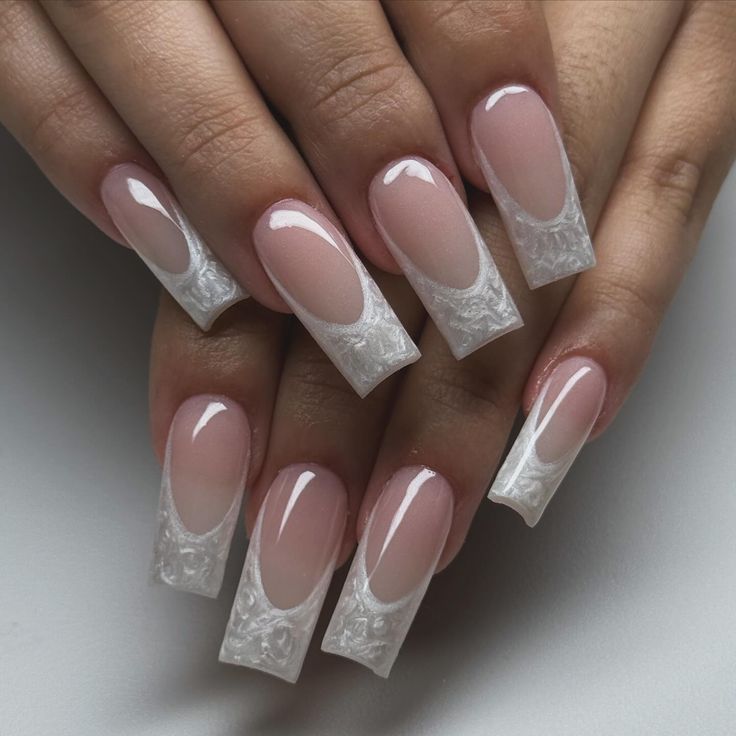 Chic Nude and White Gradient Nail Design with Intricate Textured Tips.