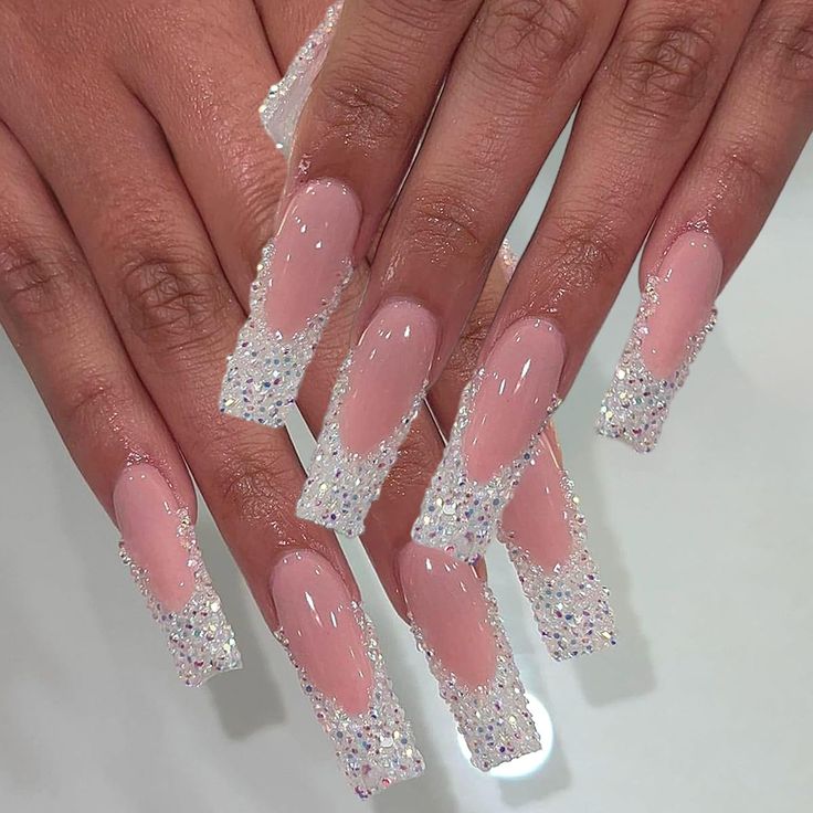 Glamorous Long Nails: Nude Base with Glittering Crystal Tips.