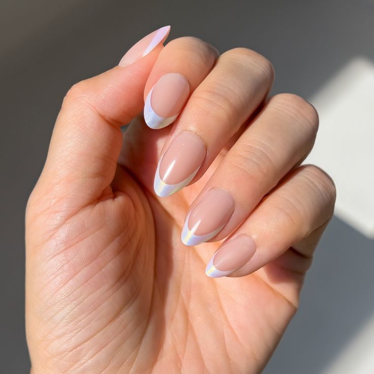 Modern Elegant Almond-Shaped French Manicure with Iridescent White Tips on Nude Base.