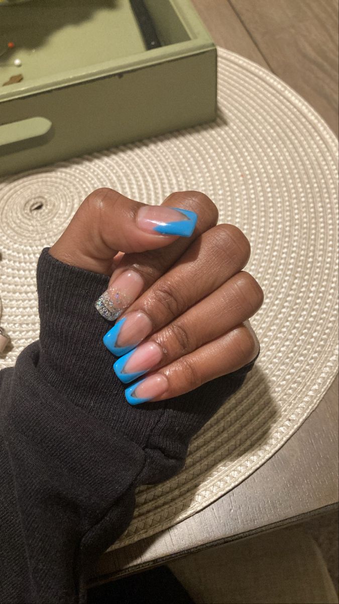 Chic Ombre Nail Design in Soft Pink and Striking Blue with Glittery Silver Accent.