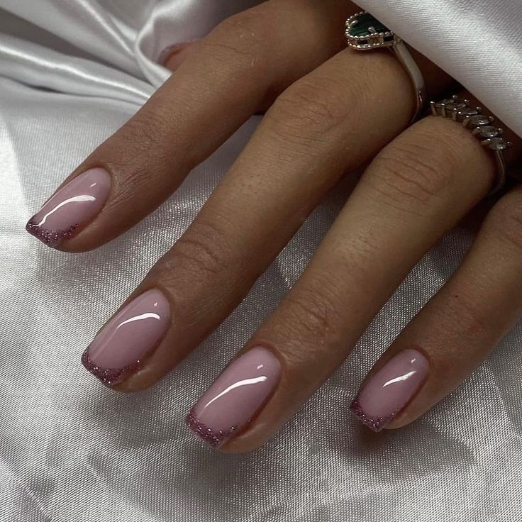 Sophisticated Nude Pink Ombre Nail Design with Glitter Accents for Versatile Occasions.