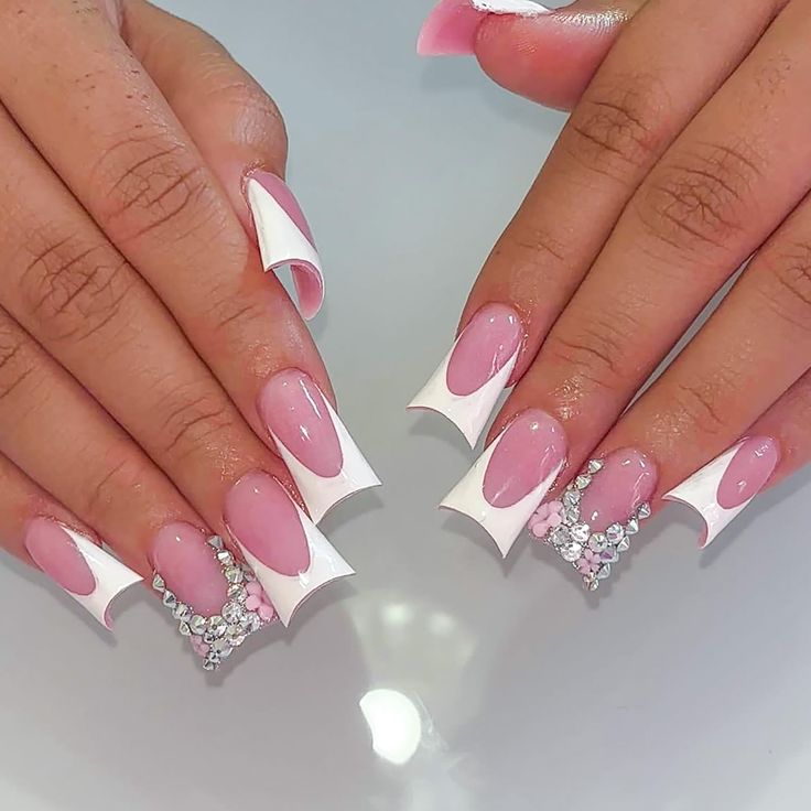 Chic Soft Pink and Bold White Nail Design with Geometric Shapes and Sparkling Rhinestones.