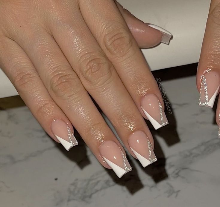 Chic Elegant French Tip Nails with Glamorous Silver Embellishments.