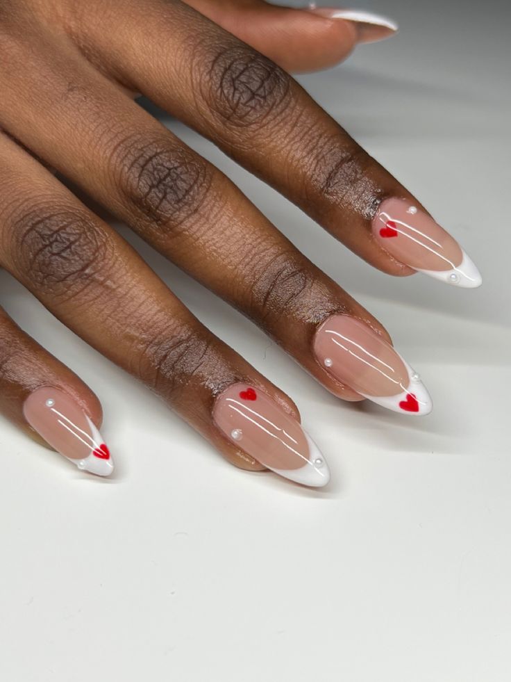 Elegant Stiletto Nails with Soft Pink Base, White Tips, and Playful Red Hearts.