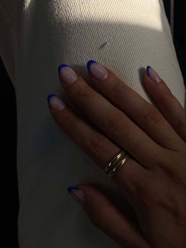 Chic Almond-Shaped Ombre Nails with Glossy Blue Tips and Gold Ring Accents