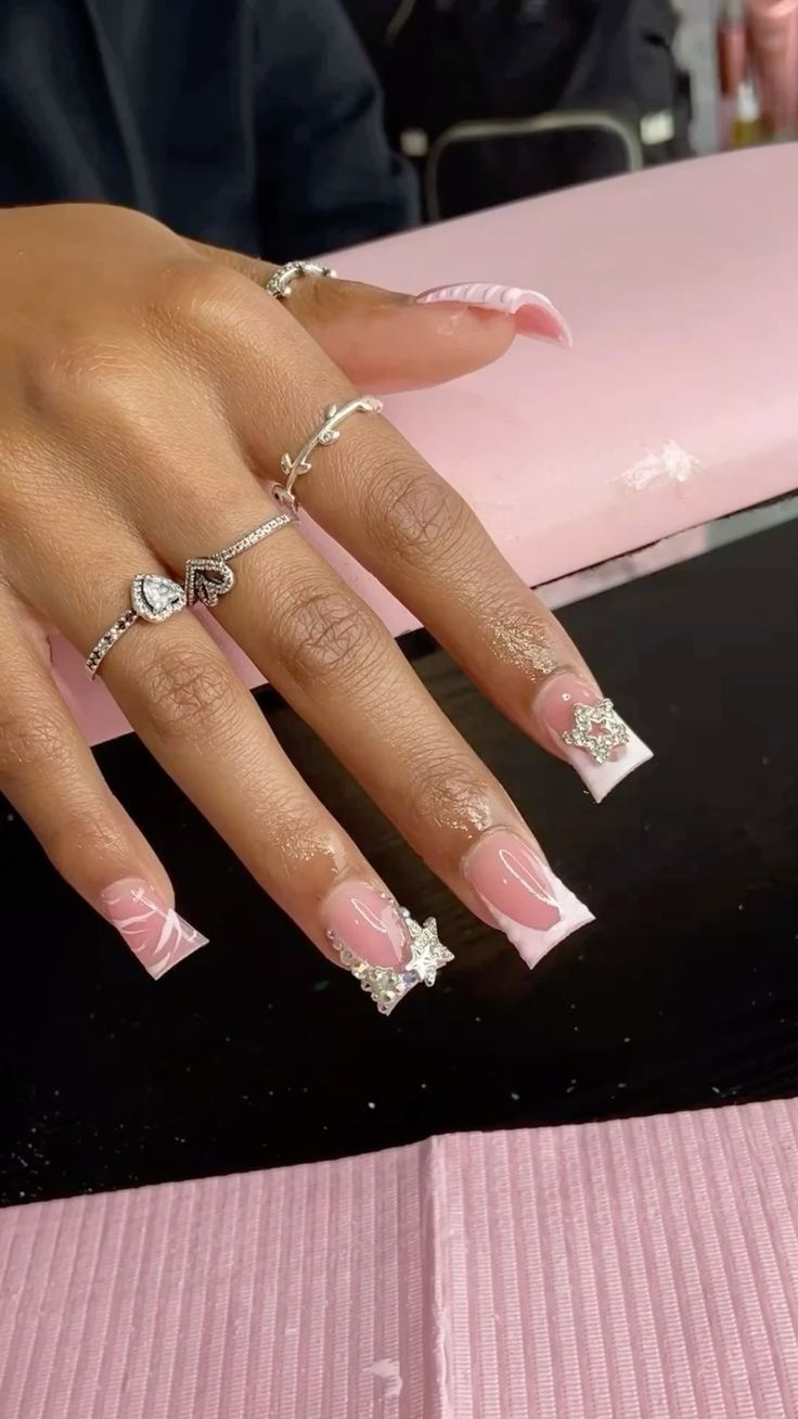 Sophisticated Elegance: Soft Pink and White Nail Design with Star Embellishments.