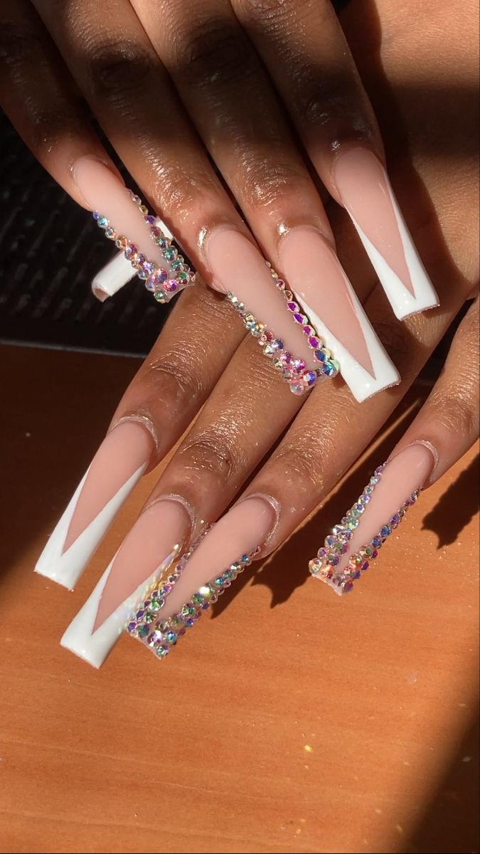 Chic Nude and White Tip Nail Design with Colorful Rhinestone Accents.