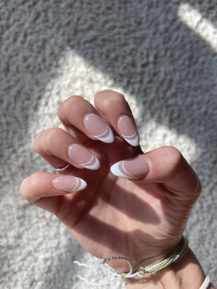 Chic Almond-Shaped Nails: Modern French Manicure with Soft Pink and Bold White Accents.