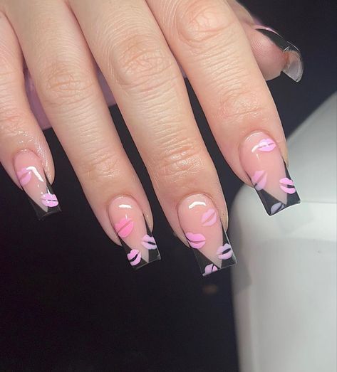 Trendy Pastel Pink and Clear Acrylic Nail Design with Black Base and Playful Lip Imprints.