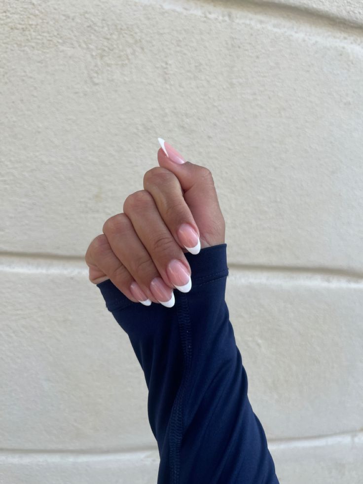 Timeless Elegance: Classic French Tip Nail Design with Soft Pink Base.