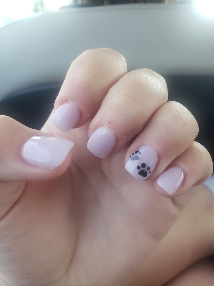 Elegant Chic Lavender Nails with Playful Paw Print Accent for Stylish Occasions.