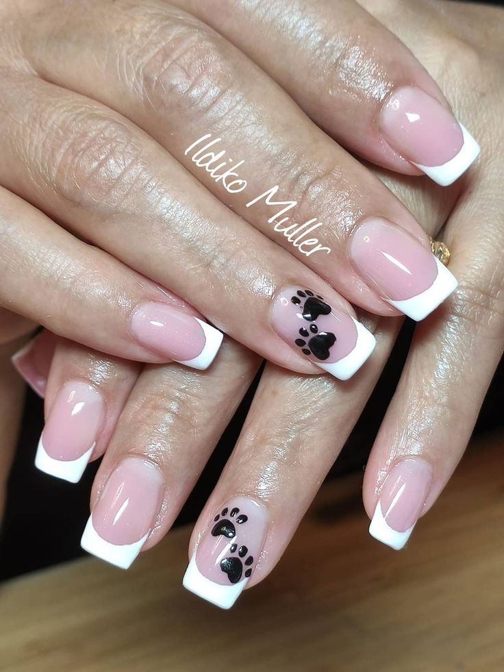 Chic French Manicure with Whimsical Paw Print and Heart Accents for Animal Lovers.