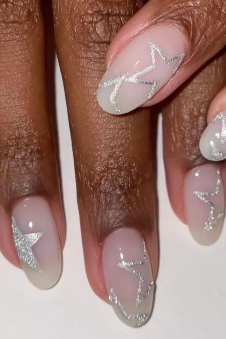 Elegant Nude Nail Design with Delicate Silver Star Accents.