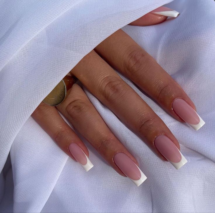 Sophisticated Soft Pink Nails with Bold White French Tips: Perfect for Any Occasion.