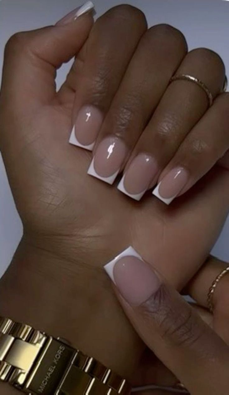 Chic French Tip Nail Design: Elegant Nude and White Combo with Glossy Finish.