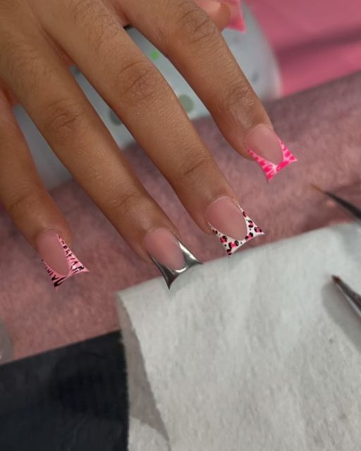 Contemporary Geometric Nail Design with Bold Pink and Silver Accents.