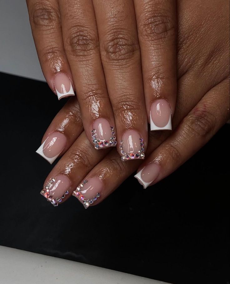 Glamorous French Tip Nails with Rhinestones for a Sophisticated Look.