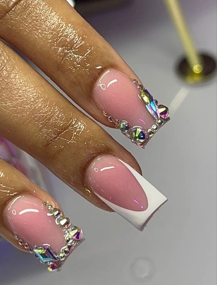 Elegant Soft Pink and White Tip Nail Design with Glamorous Rhinestone Accents.