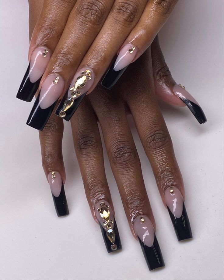 Chic Nail Design: Glossy Black Tips and Shimmering Gold Accents on Nude Base