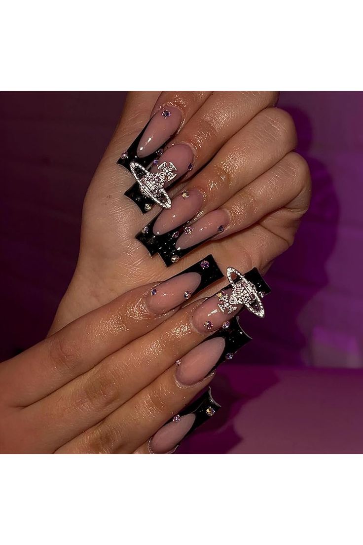 Sophisticated Stiletto Nail Design with Nude and Black Polish, Embellished with Geometric Shapes and Crystals