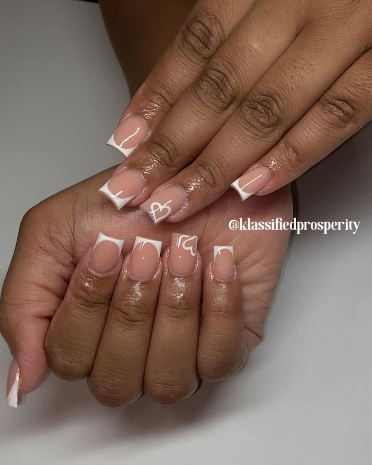 Chic and Modern Nail Design: Classic Nude Base with White Tips and Delicate Line Art.