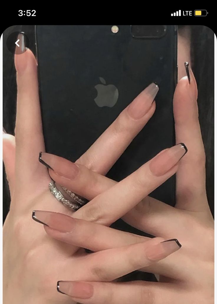 Chic Manicure: Elegant Nude and Bold Black Tip Nail Design