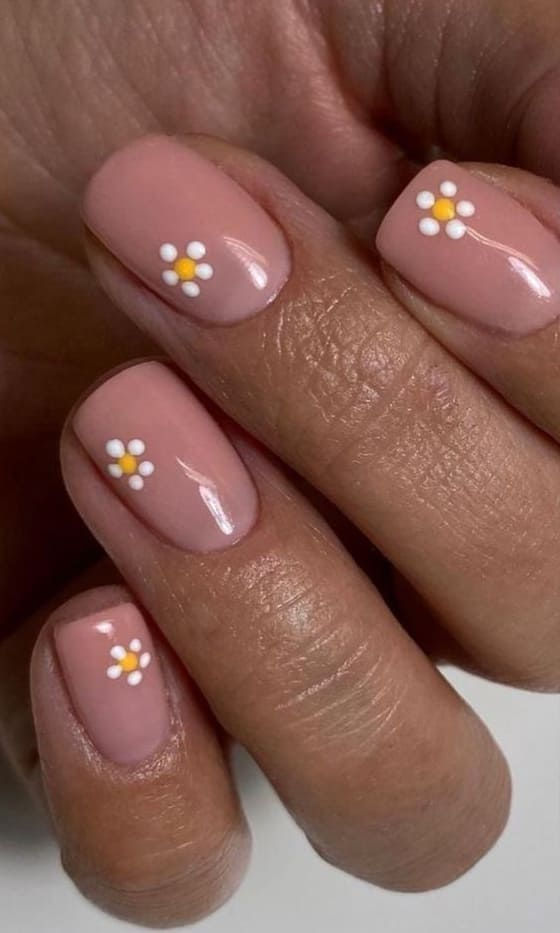 Elegant Nude Nail Art with Charming Floral Patterns in White and Yellow.