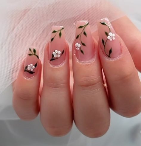 Elegant Floral Nail Design with White Flowers and Green Leaves on a Nude Base.